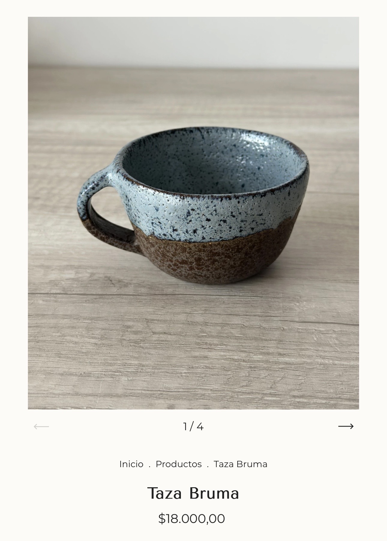 Taza Bruma · pale blue speckled mug over raw brown clay base.